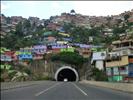 A tunnel and barrios surrounding it on the hill.